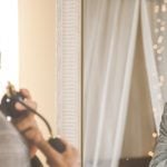 Man staring at himself in the mirror fixated on himself