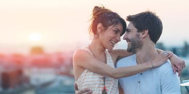 Dating over 30 symbolized by a couplewho smile at each other and embrace