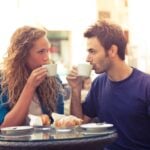 Man and woman drink coffee together and look into each other's eyes as an example that he just wants to be friends