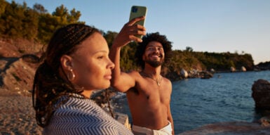 A couple standing by the water. He doesn't seem to be interested in her. She wants him to commit.
