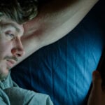 A man looking at his phone, establishing the no contact rule