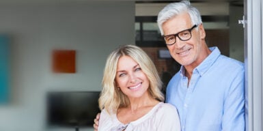 Senior couple smiling into camera as a symbol of senior dating