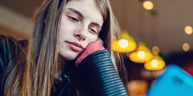 Man sits on bench facing away from woman as sign that he is not into you