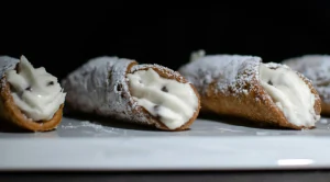 Cannoli with powdered sugar and cream