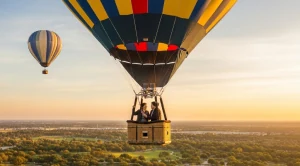 A couple enjoying a ride in an air ballon, with sunset in Irvine. 