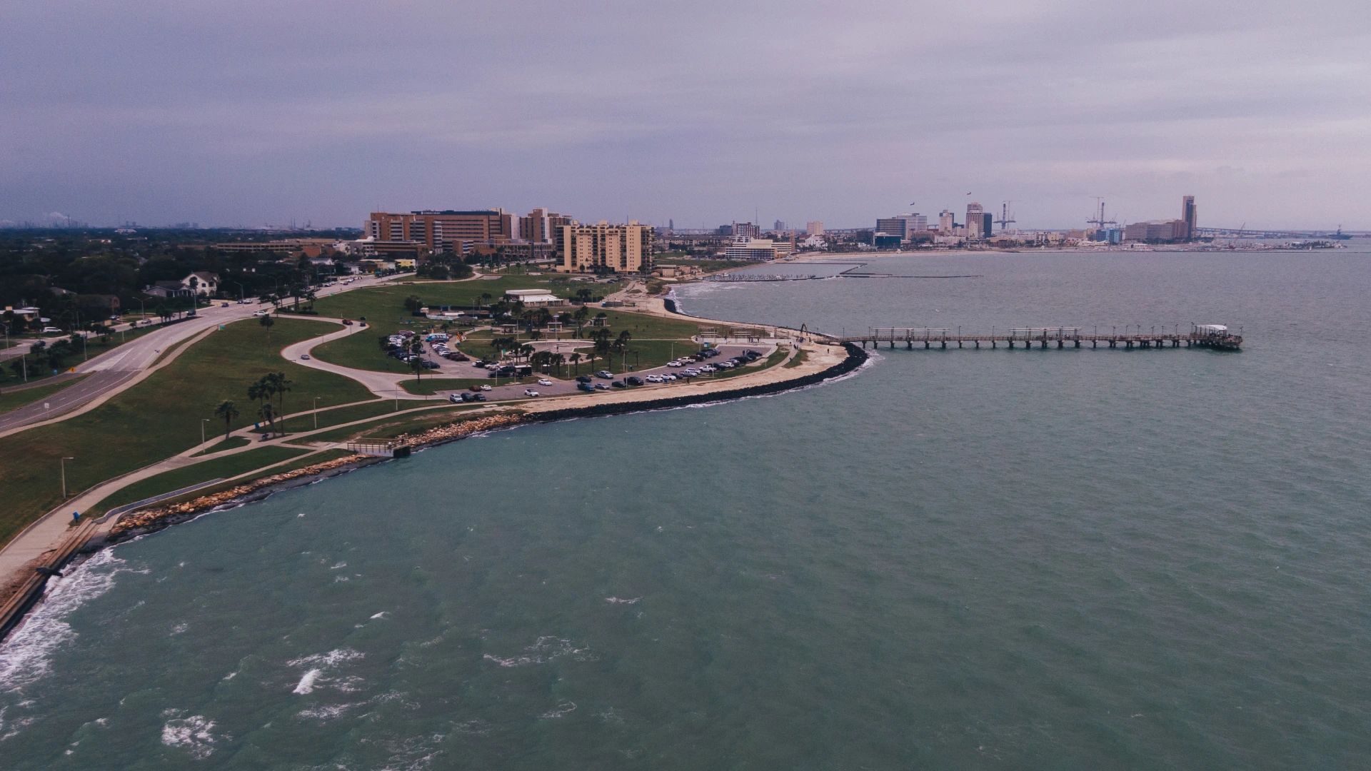 A skyline view of corpus christi with water and the beach.