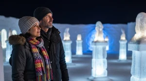 A couple visiting the alaska ice sculptures in faribanks on a date.