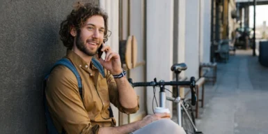 Men smiling and thinking how long should you wait to ask someone out