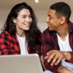 A couple sitting on the couch having a conversation