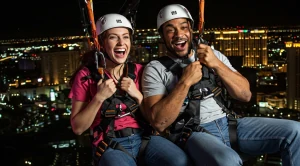 A couple enjoying the fly linq zip line in paradise, las vegas.